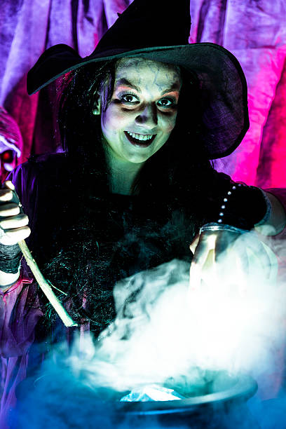 istock Halloween:  Witch cooking her brew for special guests. Zombie. 488816010