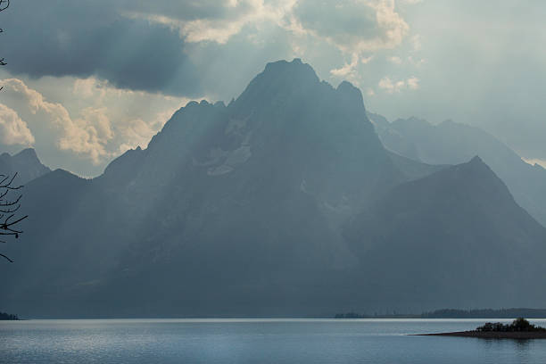 istock Hazy Teton Mountains, sun rays, Jackson Lake, Jackson Hole, Wyom 488816180