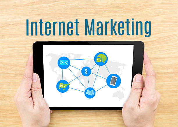 istock Hand holding tablet with Internet Marketing word on wooden table 488818006
