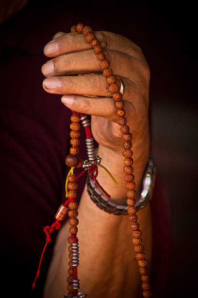 istock Tibetan hand holding Buddhist prayer beads, Boudhanath Temple, K 488818406