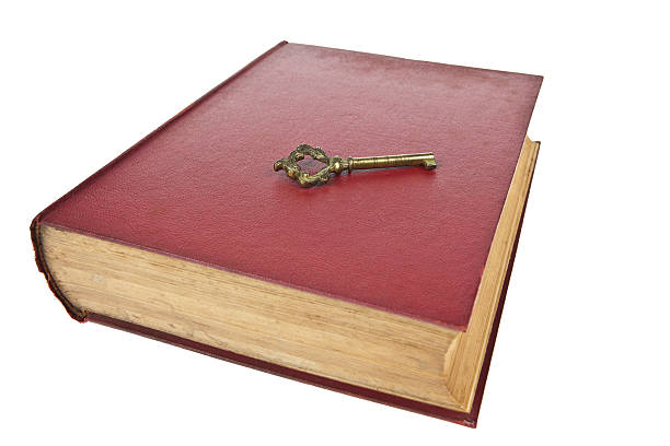 istock Old book with key isolated on white background 488819094