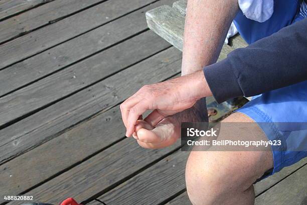 Man Checking Between His Toes Stock Photo - Download Image Now - Athlete's Foot, 2015, Barefoot