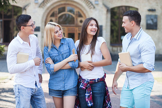 istock Attractive young friends are talking after studying 488821476