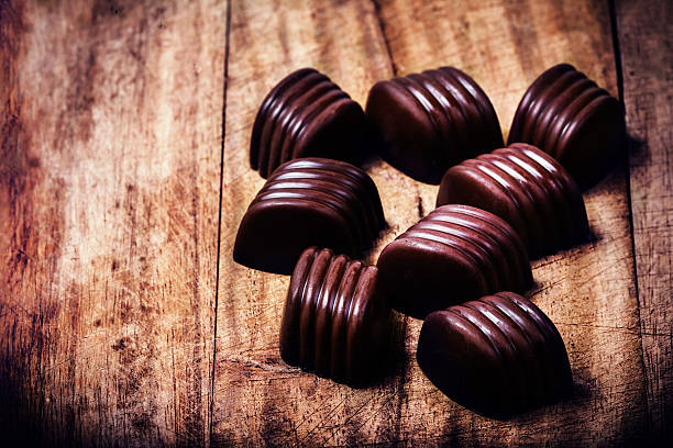 istock Chocolate truffles on wooden table with copyspace. 488826853