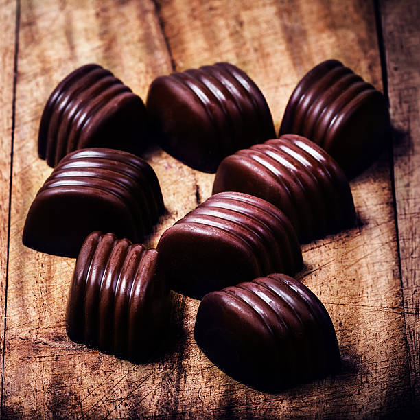 istock Chocolate truffles on wooden table with copyspace. 488826873