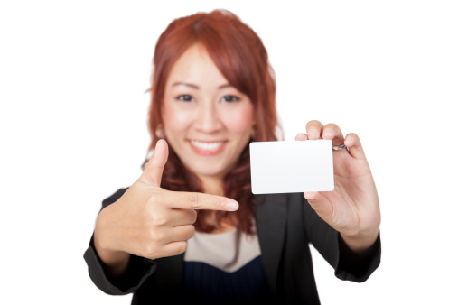 Asian office girl  happy point to a blank card  and smile focus on the card isolated on white background