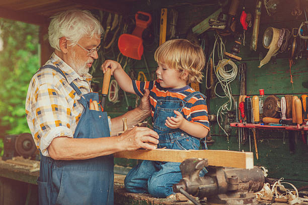 istock Grandfather and grandson in workshop 488829813