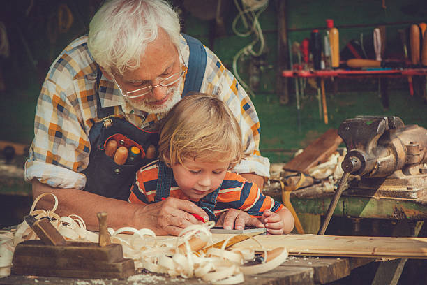 istock Grandfather and grandson in workshop 488829971