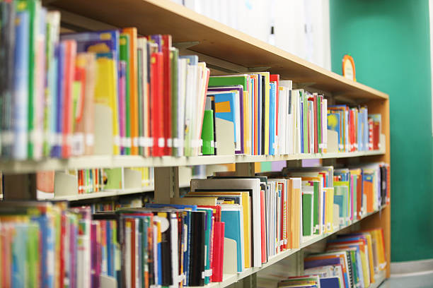 Library Bookshelf Colorful books on the bookshelf in library. picture book stock pictures, royalty-free photos & images