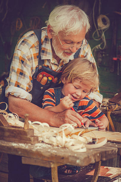 istock Grandfather and grandson in workshop 488830759