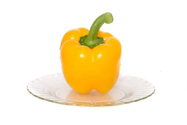 yellow pepper on white backgroundkiwi on a plate kiwi on a white background