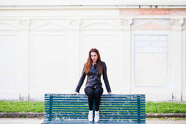 istock Cheerful woman sitting on a bench 488832523
