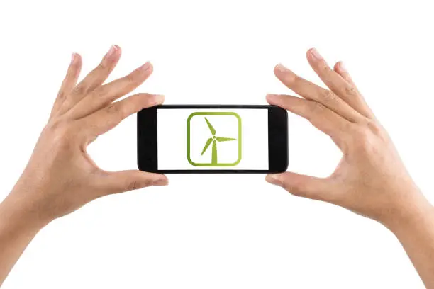 Hand holding smartphone with Wind and Solarenergy on display.