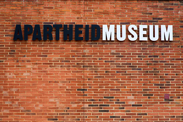 Apartheid Museum, Johannesburg Johannesburg, South Africa - March 19, 2015: Apartheid Museum, Johannesburg, South Africa. A sign at the entrance of the Apartheid Museum. The stark effect of Black and white lettering on the external brick wall are symbolic of the cultural differences that existed under apartheid. apartheid sign stock pictures, royalty-free photos & images