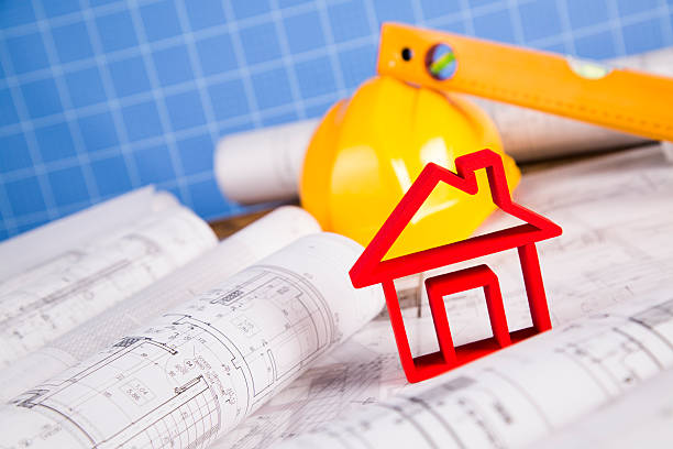 istock Architectural project and Yellow helmet and house model 488839092