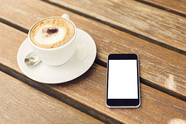 istock blank cell phone and cup of coffee 488840860