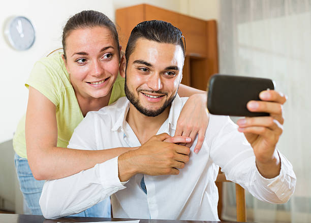 istock couple taking selfie with smartphone 488840944