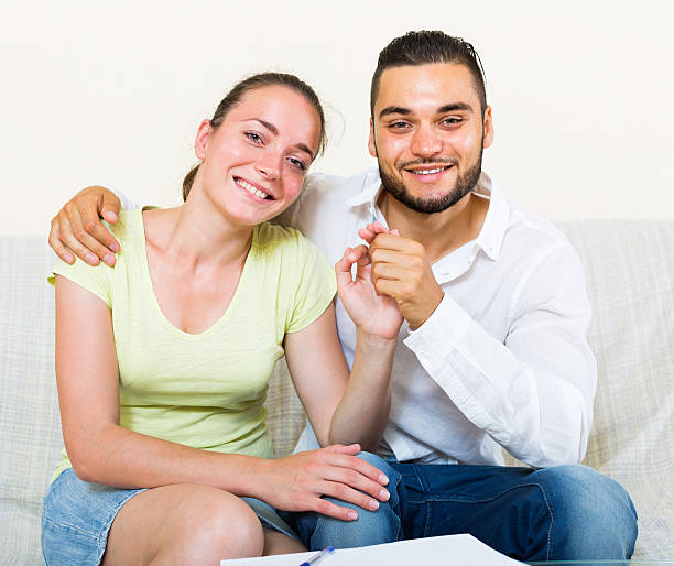 istock pair smiling and embracing indoors 488841438