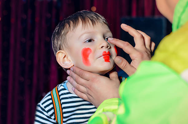 istock Cute Boy Applied with Funny Makeup by an Artist 488844190
