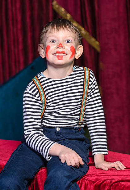 istock Cute excited little boy in comic red makeup 488844300