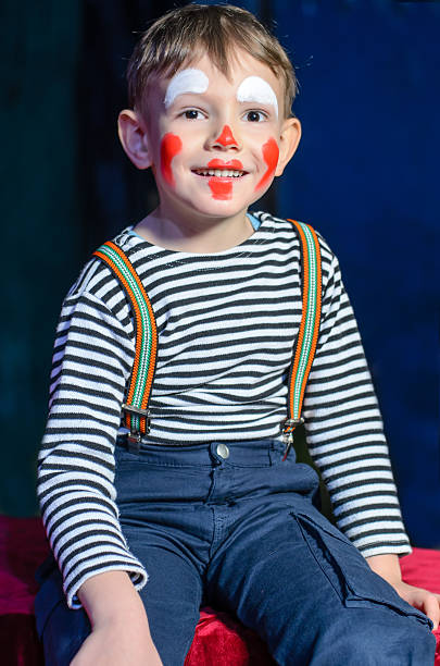 istock Cute excited little boy in comic red makeup 488844342