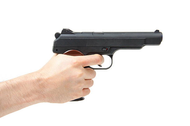 istock Man's hand holding gun, isolated on white 488844546