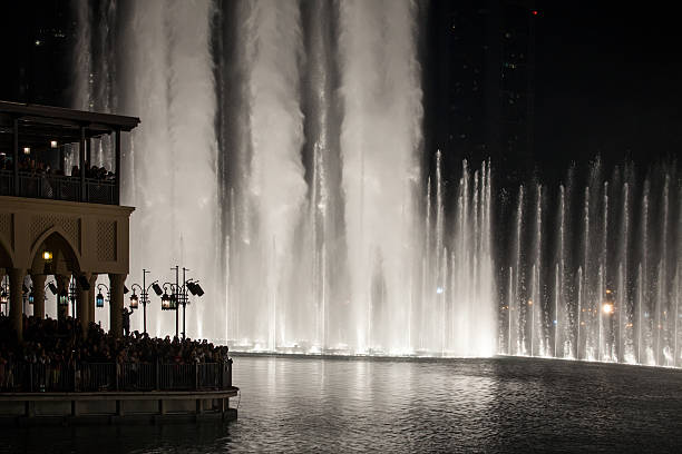 istock People watching water fountains downtown Dubai, UAE 488845046