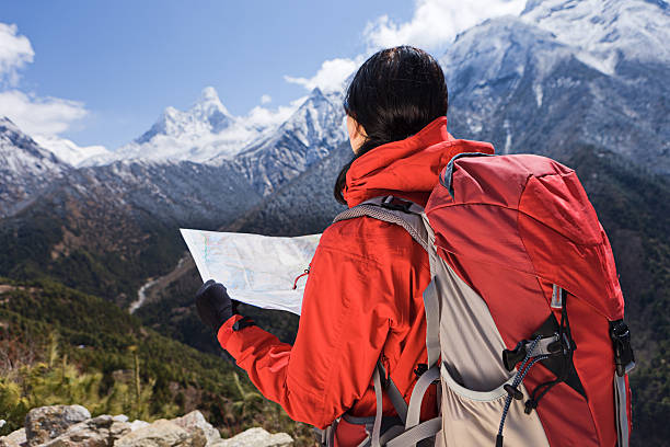 istock Woman looking at the map in Himalayas, Nepal 488847296