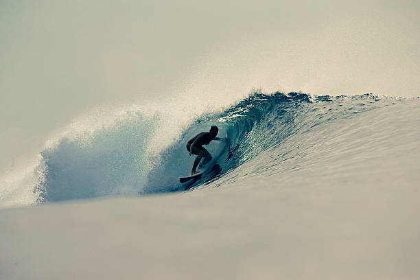 istock Backlit surfer girl gets barreled 488847850