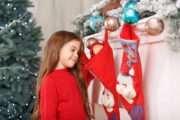 istock Little girl standing near fireplace 488848756