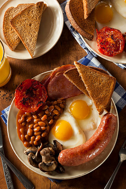 Traditional Full English Breakfast Traditional Full English Breakfast with Eggs, Bacon, Sausage, and Baked Beans english breakfast stock pictures, royalty-free photos & images