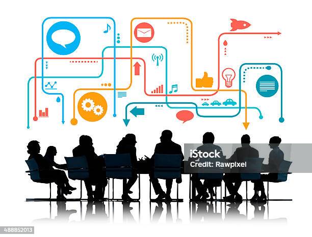 Silhouettes Of Business People Meeting With Social Media Symbols Stock Photo - Download Image Now