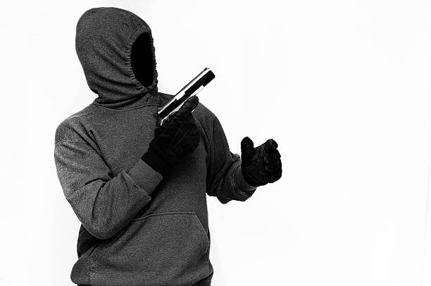 istock Criminal in Mask with Gun 488854371