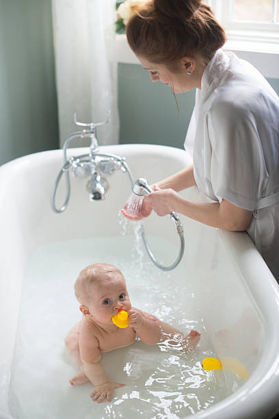 istock Mom giving baby bath 488855025