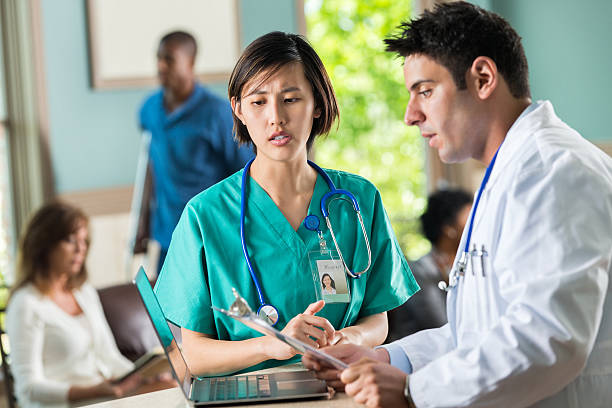 istock Busy waiting room with nurse and doctor conversing 488855571
