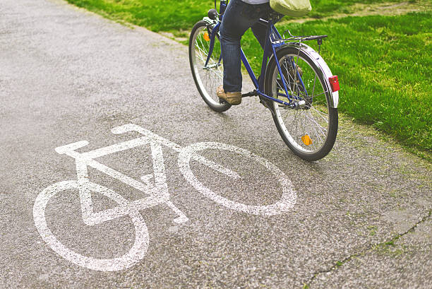istock Woman riding bicycle on a bike path 488856277