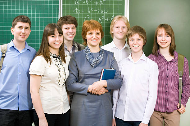 istock Schoolboys and schoolgirls with teacher 488868835