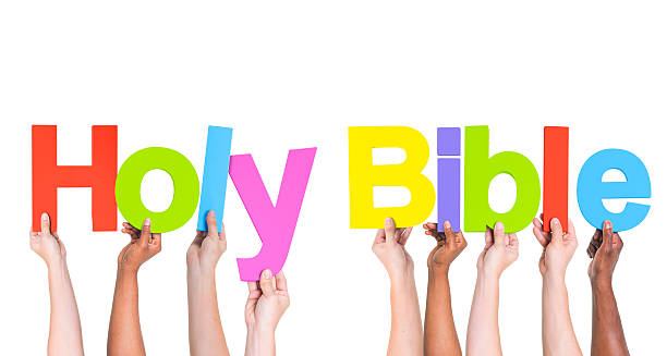 istock Group of Multiethnic Hands Holding Word Holy Bible 488869101
