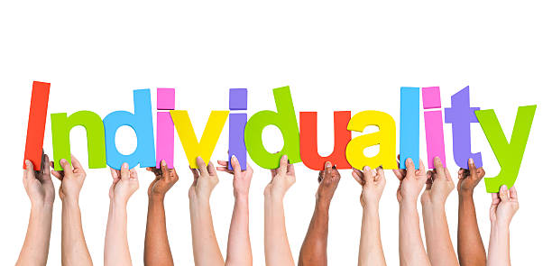 istock Multiethnic Group of Hands Holding Word Individuality 488869103