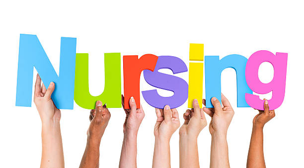 istock Multiethnic Group of Hands Holding Word Nursing 488869107