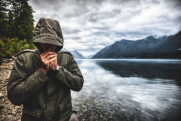 Solitude man pensive on the lake side Solitude man pensive on the lake side spirituality adventure searching tranquil scene stock pictures, royalty-free photos & images