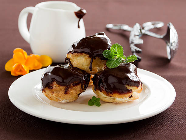 istock profiteroles with cream and chocolate sauce. 488870277