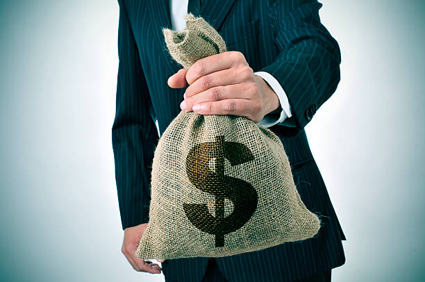 istock businessman with a burlap money bag 488870343