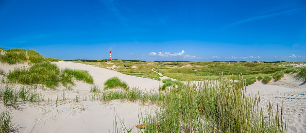 Beautiful dune landscape with traditional lighthouse on the island of Amrum at North Sea, Schleswig-Holstein, Germany