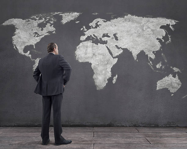 istock Businessman and World Map Painting on the Wall 488871862