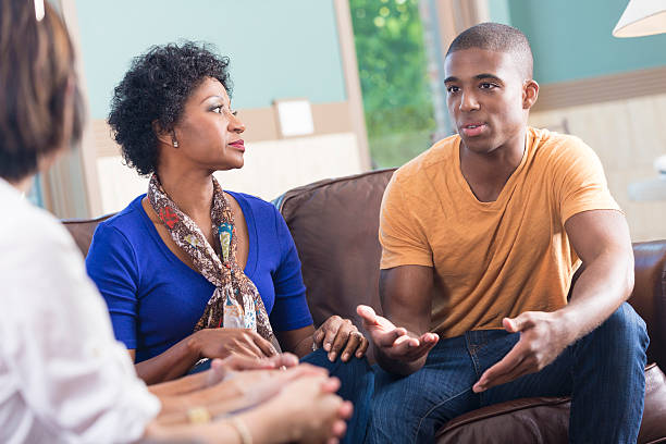istock Support group listening to young man telling story during meeting 488872295