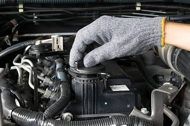 istock mechanic is opening the oil cap from a car engine. 488872602