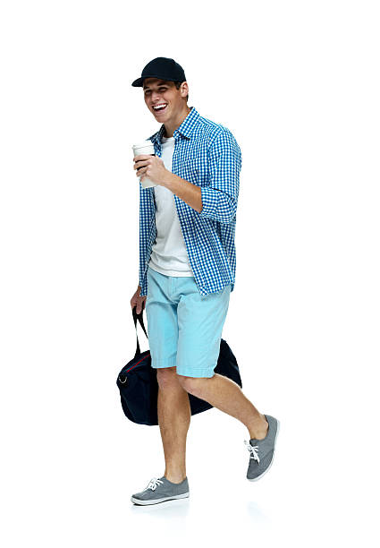 istock Happy man walking with duffle bag and disposable cup 488874267