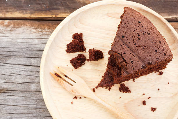 istock Chocolate cake on wooden plate. 488875290