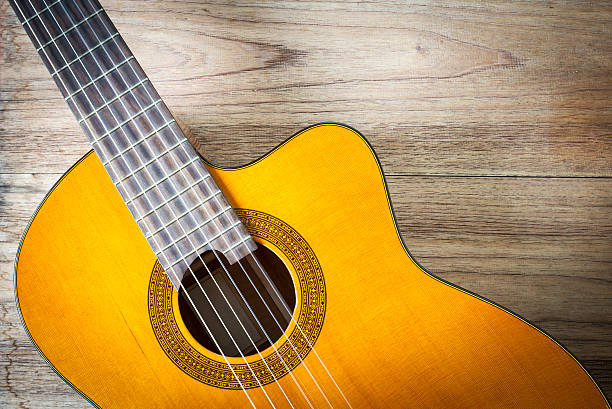 istock Guitar on wood background. 488875474
